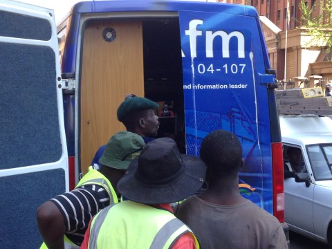 3_Public interest… opposite the Pretoria court house news-vans were broadcasting the verdict live. These workers were glued to Judge Masipa's every word.JPG