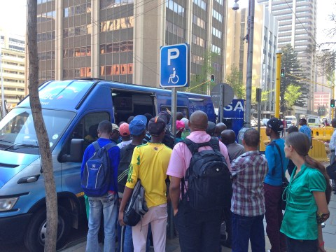 8_Attention grabbing_SABC news-van broadcasting the verdict live from opposite the court house. As the day went by, more and more people stopped to watch and listen in.JPG