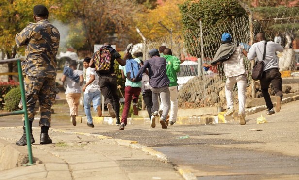 Students running from police during protests at National University of Lesotho_photo by Justice Kalebe
